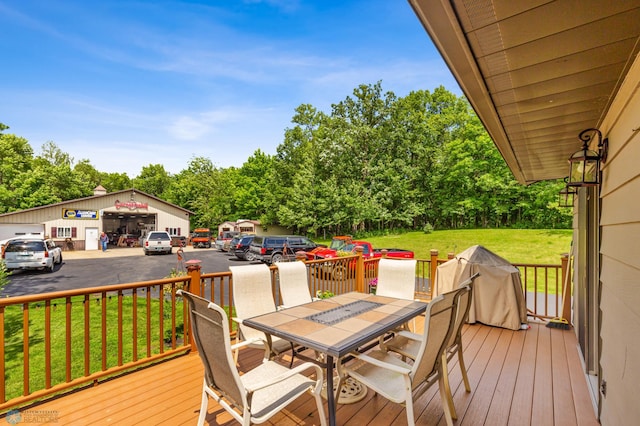 wooden terrace with a garage and a yard