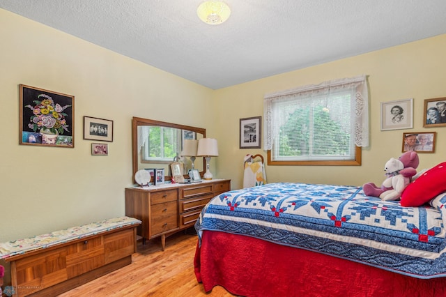 bedroom featuring a textured ceiling and hardwood / wood-style flooring