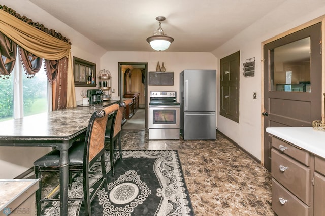 kitchen featuring electric stove, pendant lighting, stainless steel refrigerator, and dark tile patterned floors