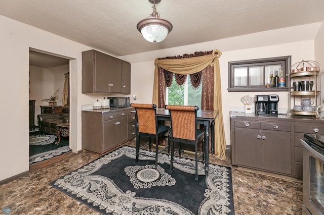 office area featuring dark tile patterned floors and a textured ceiling