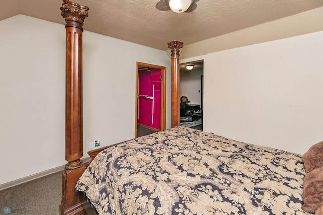 bedroom with ceiling fan, carpet floors, and a textured ceiling