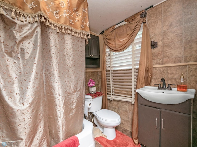 full bathroom featuring shower / bath combination with curtain, tile walls, decorative backsplash, toilet, and vanity