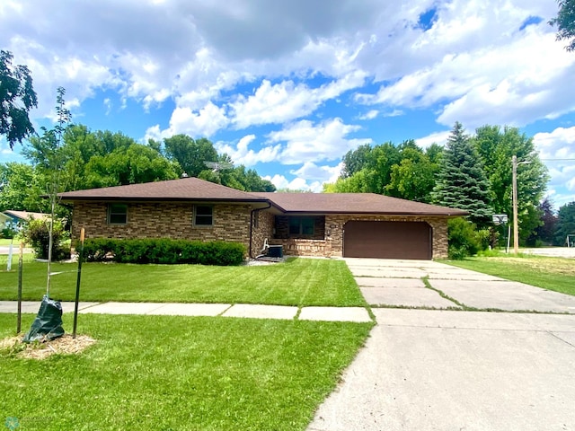 single story home featuring a garage and a front yard