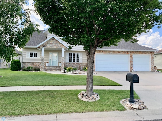 craftsman inspired home featuring a garage and a front yard