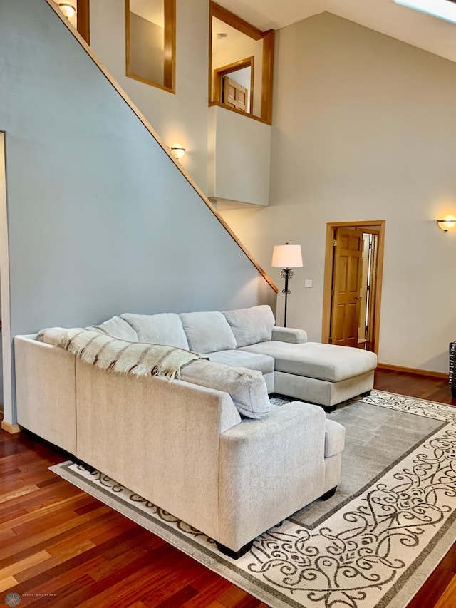 living room featuring dark hardwood / wood-style flooring and high vaulted ceiling