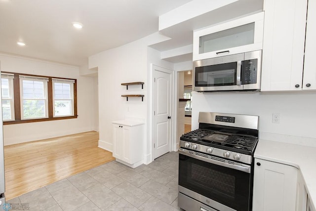 kitchen featuring white cabinetry, appliances with stainless steel finishes, and light tile patterned floors