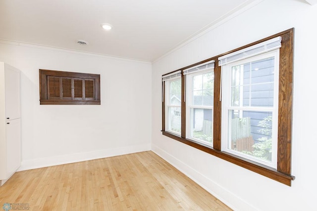 unfurnished room featuring light hardwood / wood-style flooring and ornamental molding