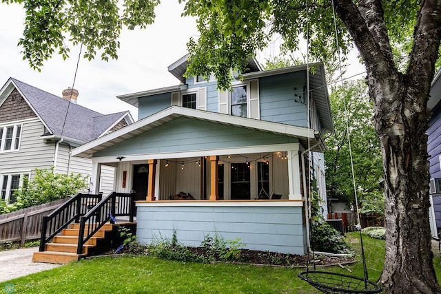 view of front of property with covered porch and a front lawn