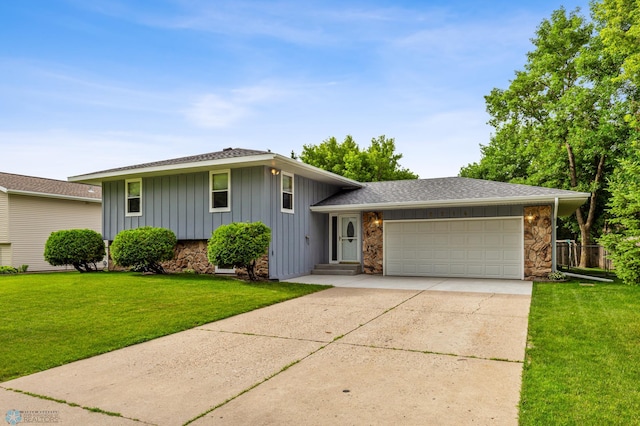 tri-level home with a garage and a front yard