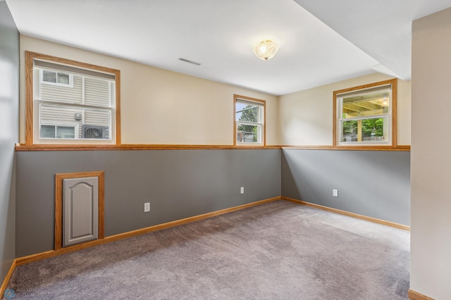 unfurnished room featuring carpet flooring and a healthy amount of sunlight