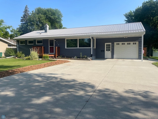 single story home with a garage and a front yard