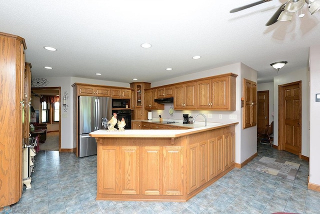 kitchen with kitchen peninsula, ceiling fan, black appliances, and light tile patterned floors