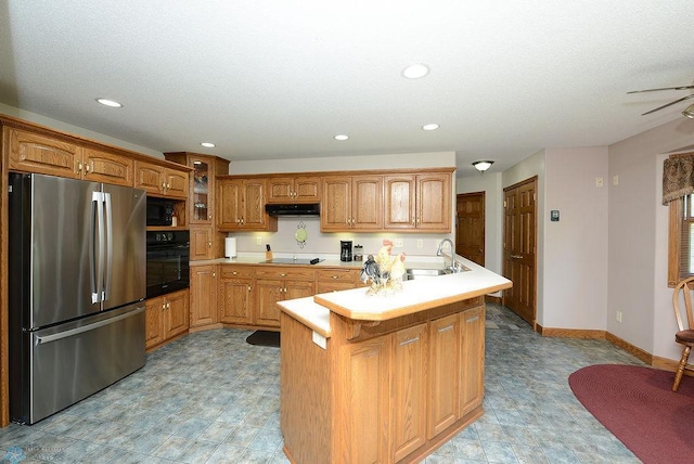 kitchen with sink, range hood, black appliances, and light tile patterned floors