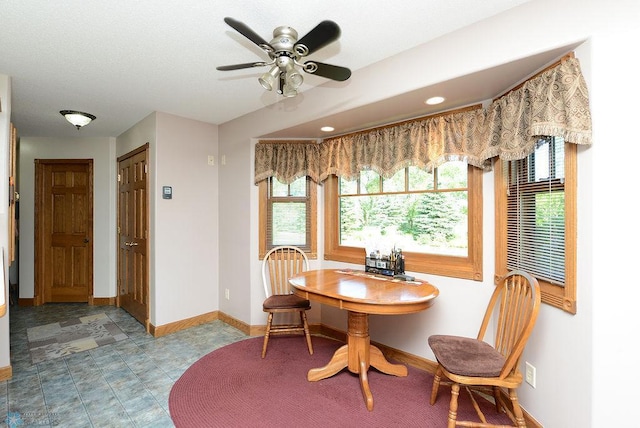 tiled dining space featuring ceiling fan