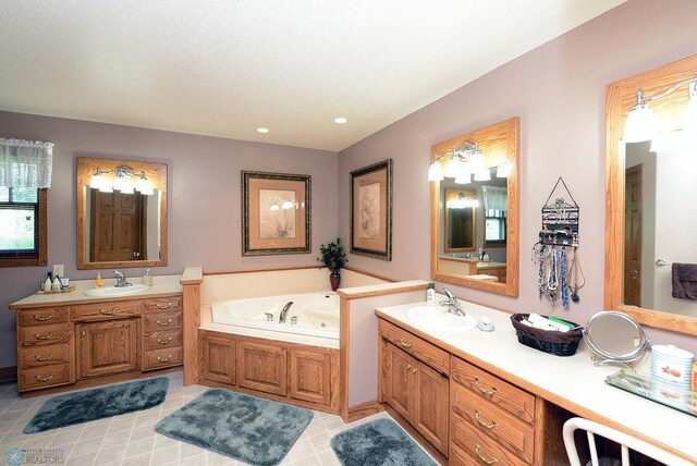 bathroom with tile patterned flooring, a bathing tub, and vanity