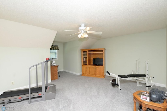 workout area with a textured ceiling, lofted ceiling, light colored carpet, and ceiling fan