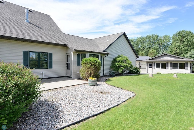 rear view of house with a yard