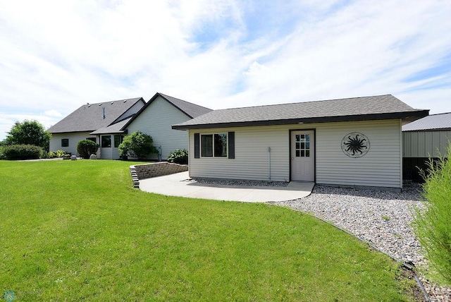 rear view of house featuring a lawn