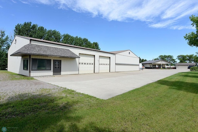 view of front of property with a garage and a front lawn