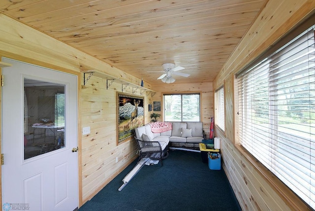 unfurnished sunroom featuring wooden ceiling and ceiling fan