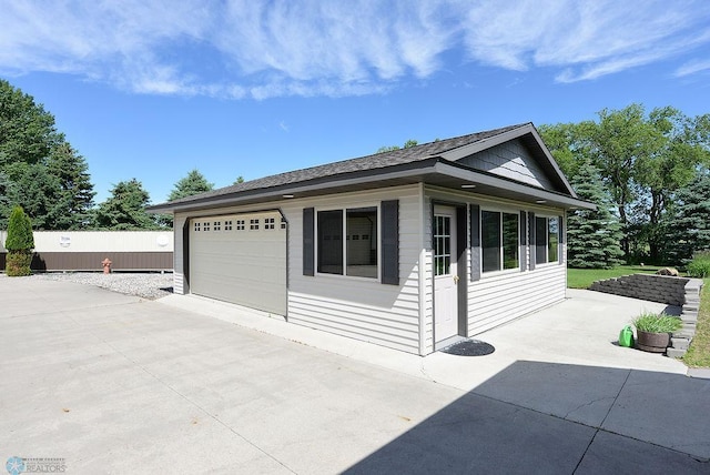 view of side of home featuring a garage