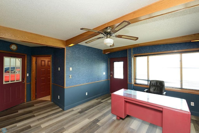 office with ceiling fan, a textured ceiling, hardwood / wood-style flooring, and beam ceiling