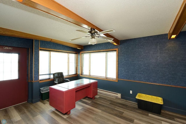 office space with ceiling fan, dark hardwood / wood-style flooring, lofted ceiling with beams, a baseboard radiator, and a textured ceiling