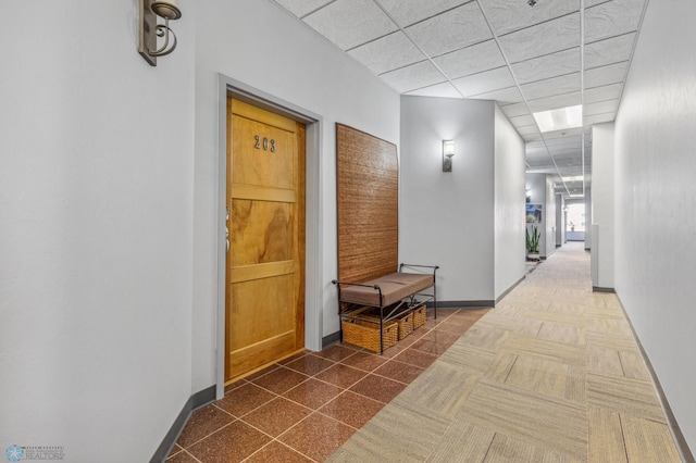 hall featuring a paneled ceiling