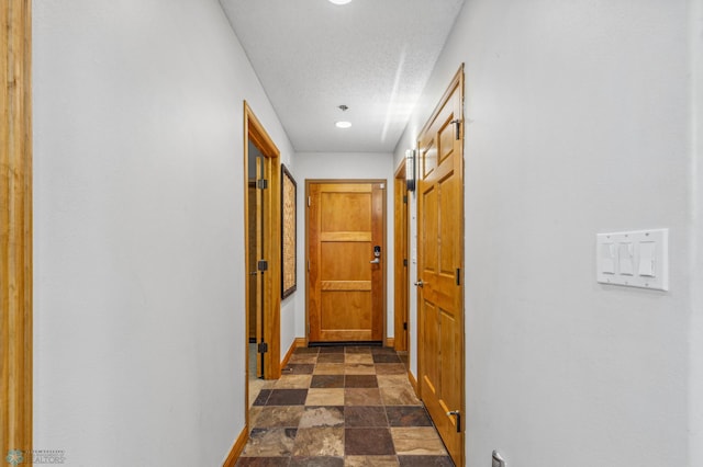 corridor with dark tile patterned flooring