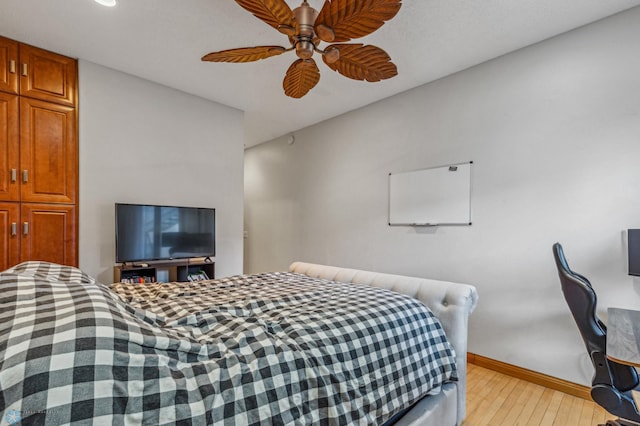 bedroom with light hardwood / wood-style floors and ceiling fan