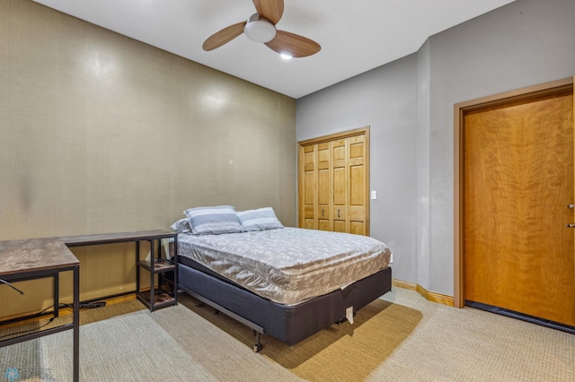 bedroom with ceiling fan, carpet flooring, and a closet