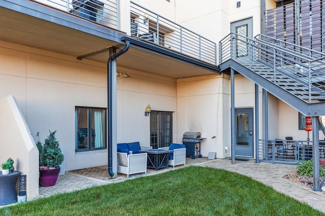 exterior space featuring a balcony and a grill