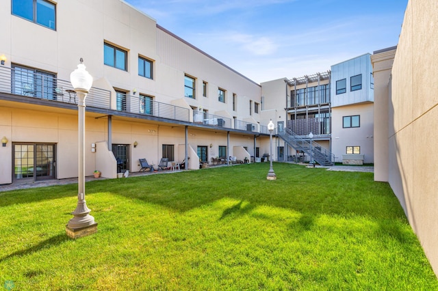 view of home's community featuring a patio and a yard