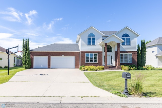 view of front of house with a garage and a front yard