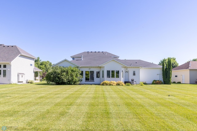 back of house with a lawn