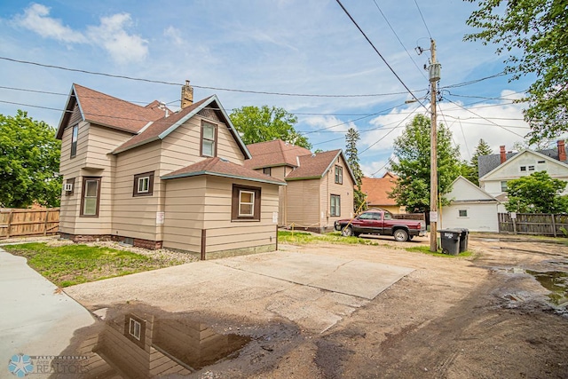 view of home's exterior featuring a garage and an outbuilding