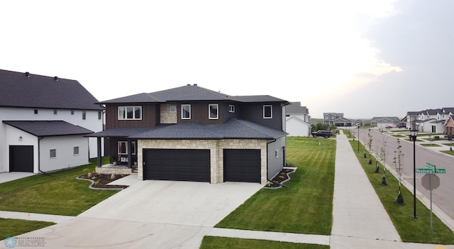 view of front of property featuring a garage and a front lawn