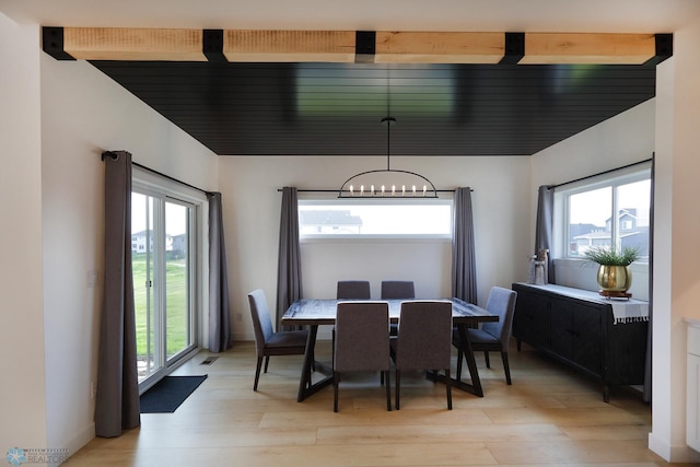 dining space with a chandelier, light hardwood / wood-style flooring, and a wealth of natural light