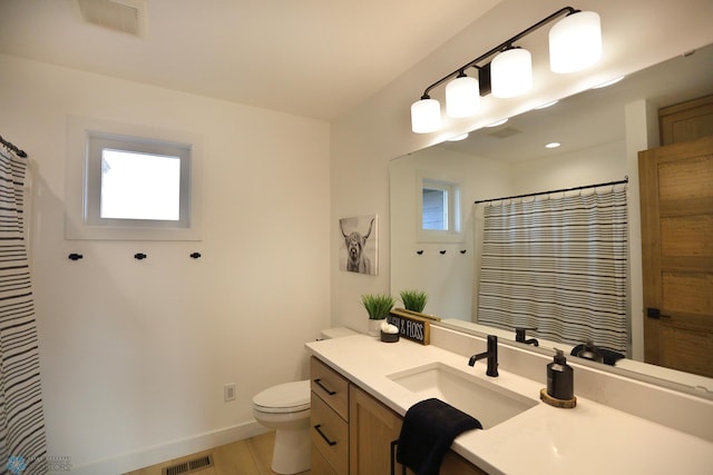 bathroom with hardwood / wood-style floors, vanity, and toilet