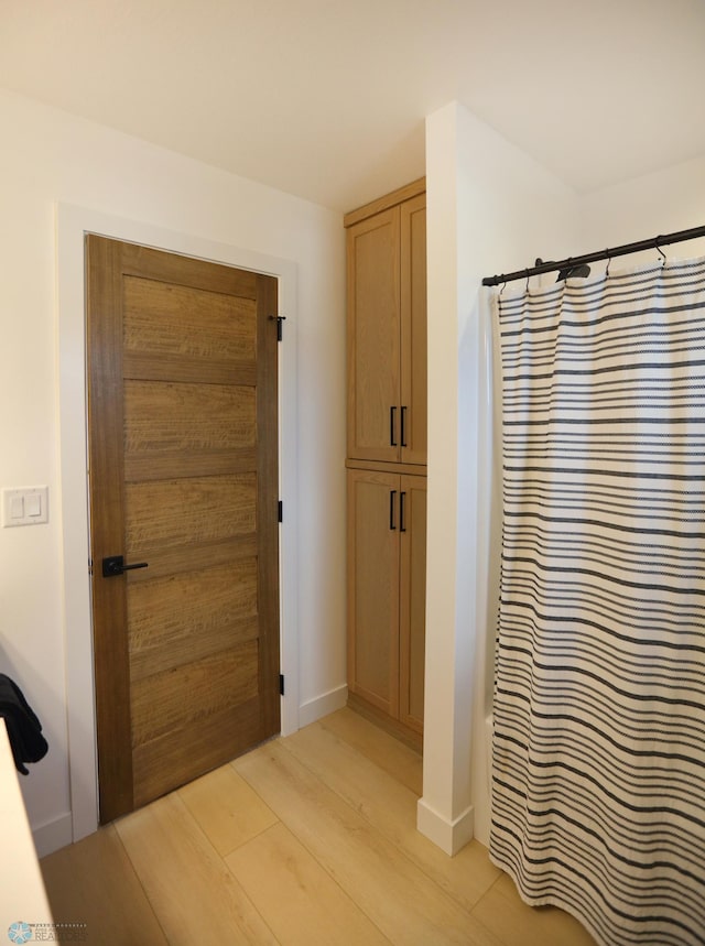 bathroom with wood-type flooring