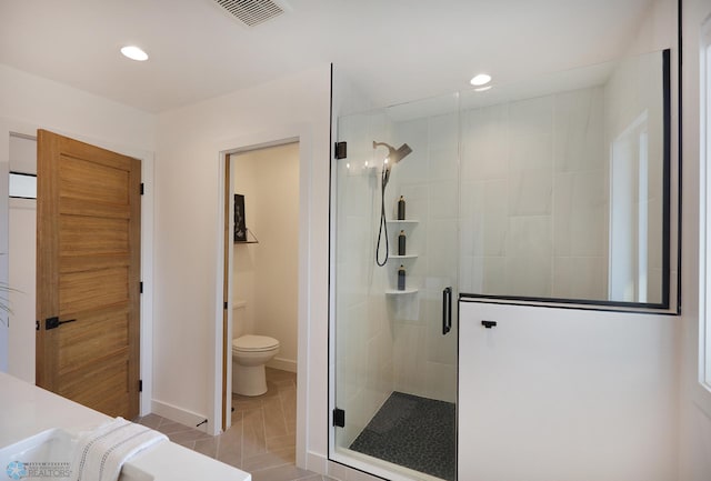 bathroom with toilet, tile patterned floors, and walk in shower