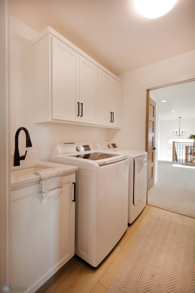 washroom with sink, separate washer and dryer, cabinets, and light colored carpet