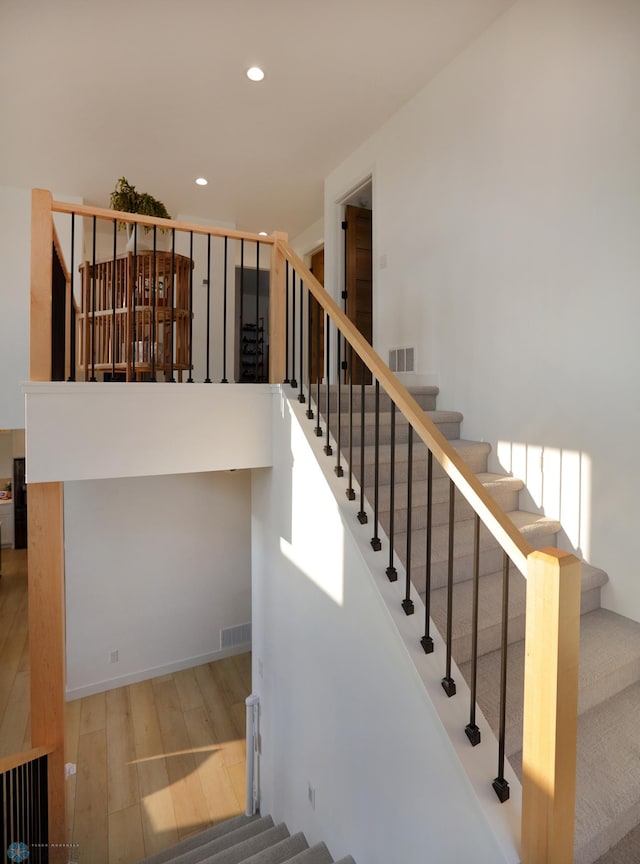 stairway with hardwood / wood-style floors