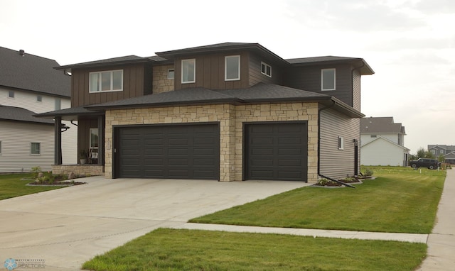 prairie-style house with a garage and a front lawn