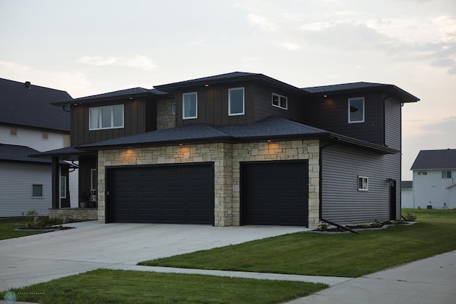 prairie-style house featuring a garage and a front yard