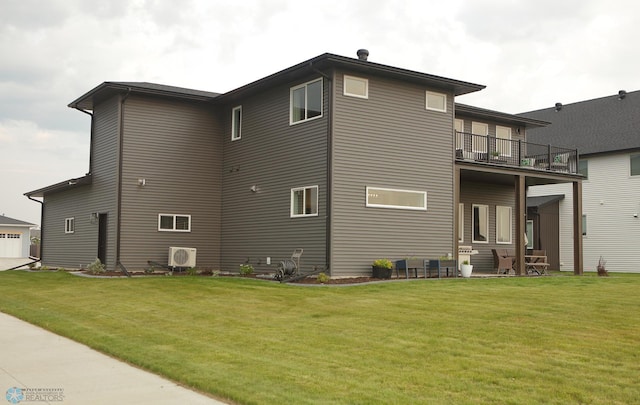 rear view of property featuring a balcony, a garage, and a lawn