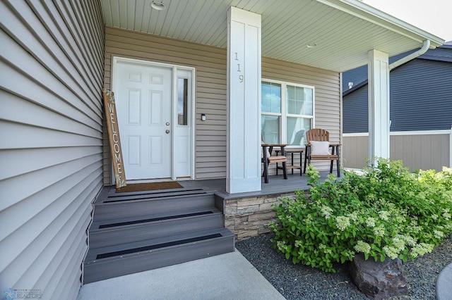 view of exterior entry with covered porch