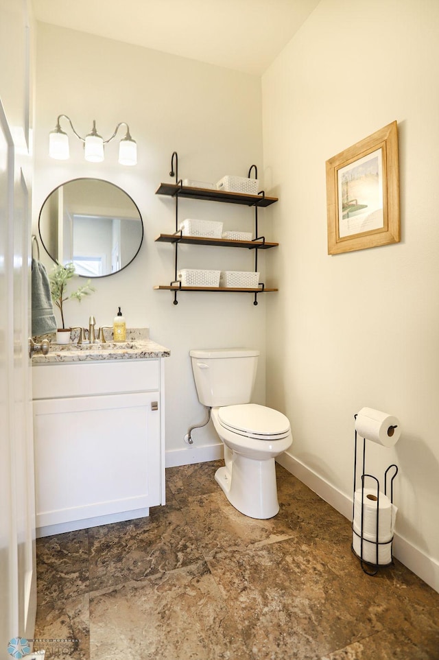 bathroom with vanity, tile patterned flooring, and toilet