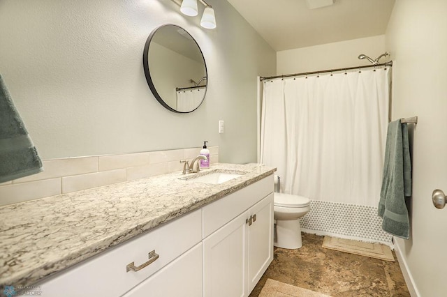 bathroom featuring decorative backsplash, tile patterned floors, toilet, and vanity