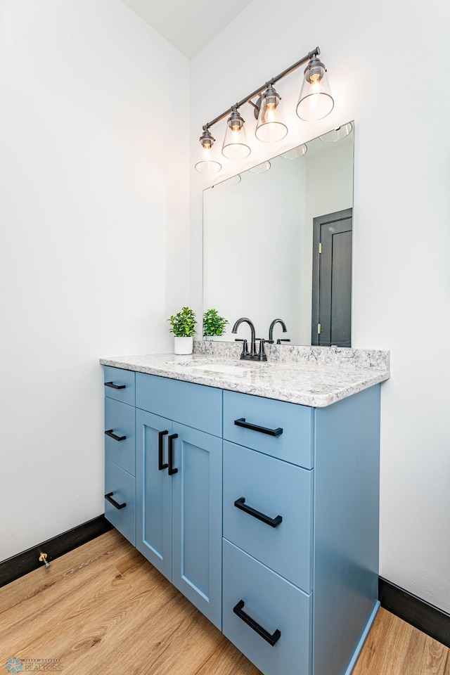 bathroom featuring hardwood / wood-style floors and vanity